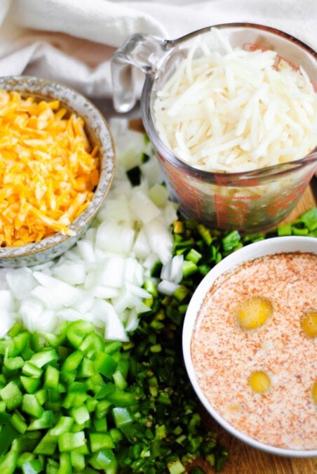 Ingredients for Spanish breakfast casserole in separate bowls.