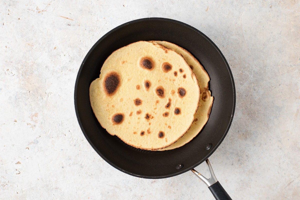 Two tortillas in a skillet. 