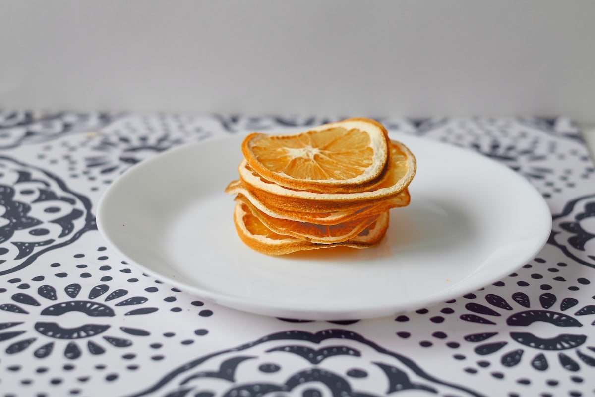 Slices of dehydrated oranges on a plate. 