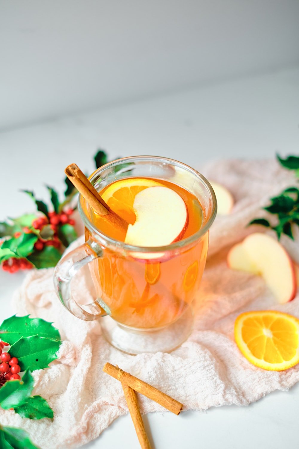 Single mug of Christmas tea with garnish.