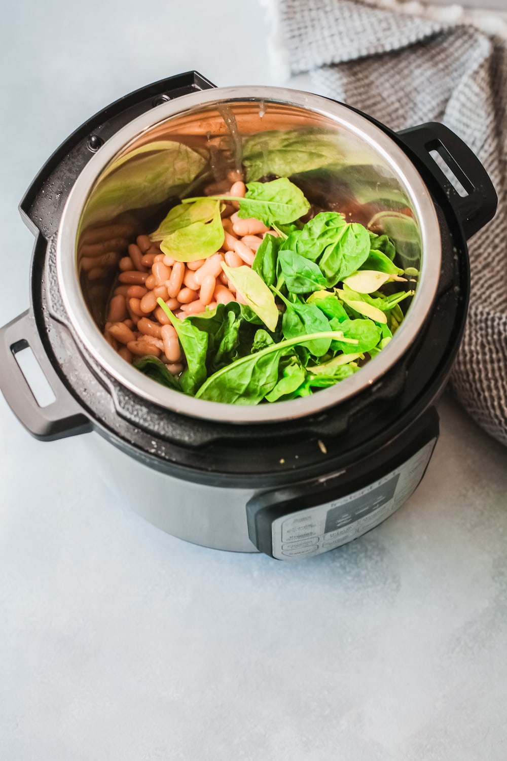 Cannellini beans and spinach in an instant pot.