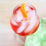 Venetian Blush Campari orange cocktail with a green napkin.