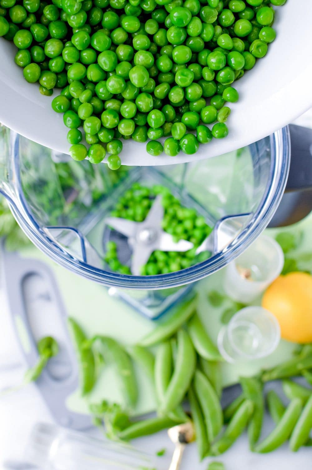Adding the peas to the blender.