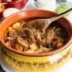 Guatemalan hilachas in a yellow bowl with a wooden spoon.