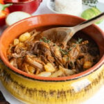 Guatemalan hilachas shredded beef stew in a yellow bowl.