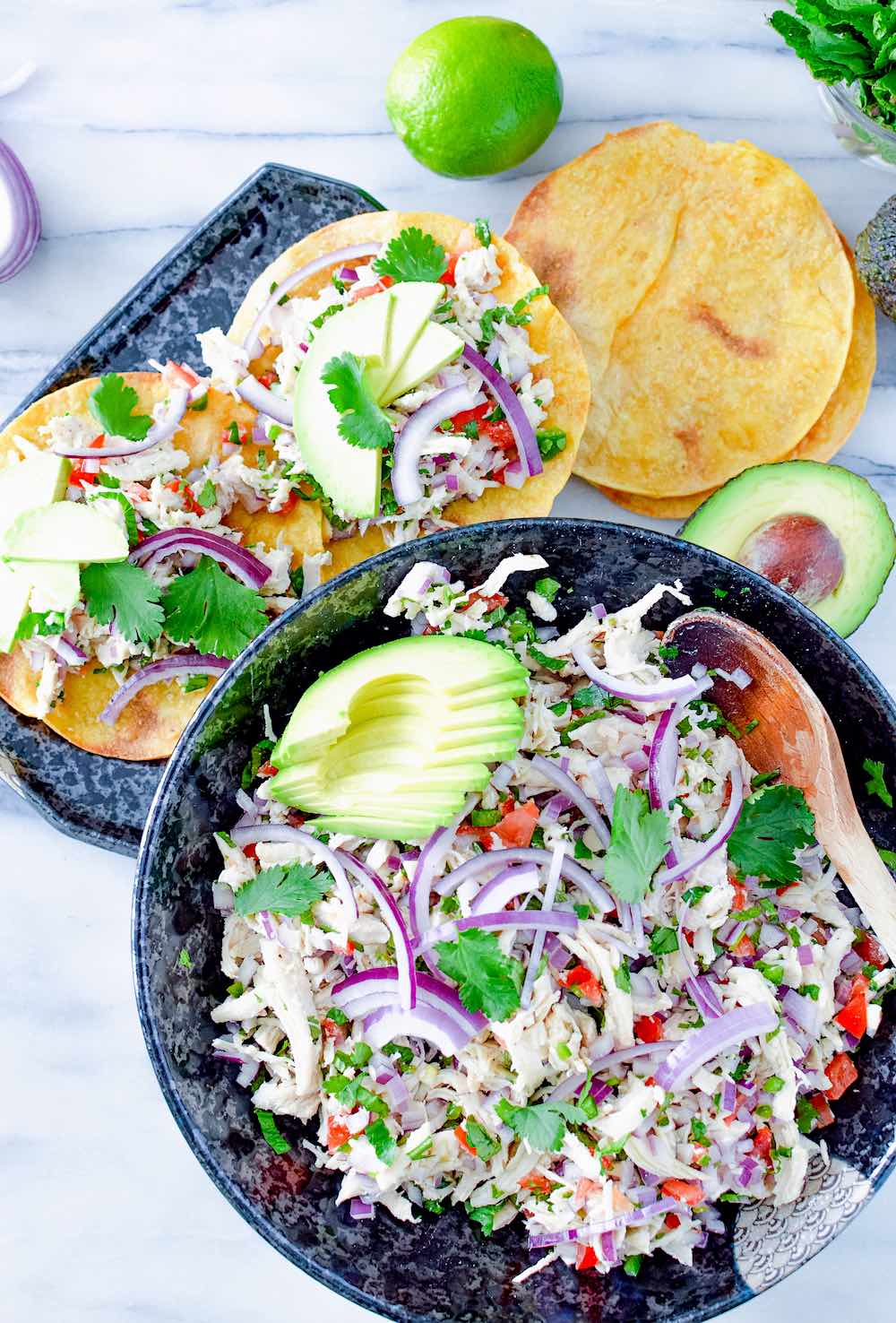 Guatemalan salpicon de pollo in a bowl and on crispy tostadas. 