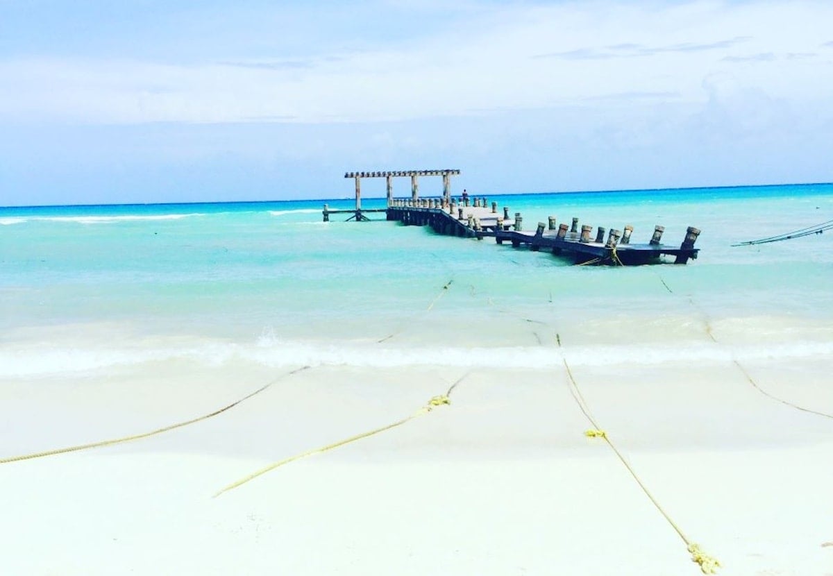 Dock in blue water in Playa del Carmen Mexico.