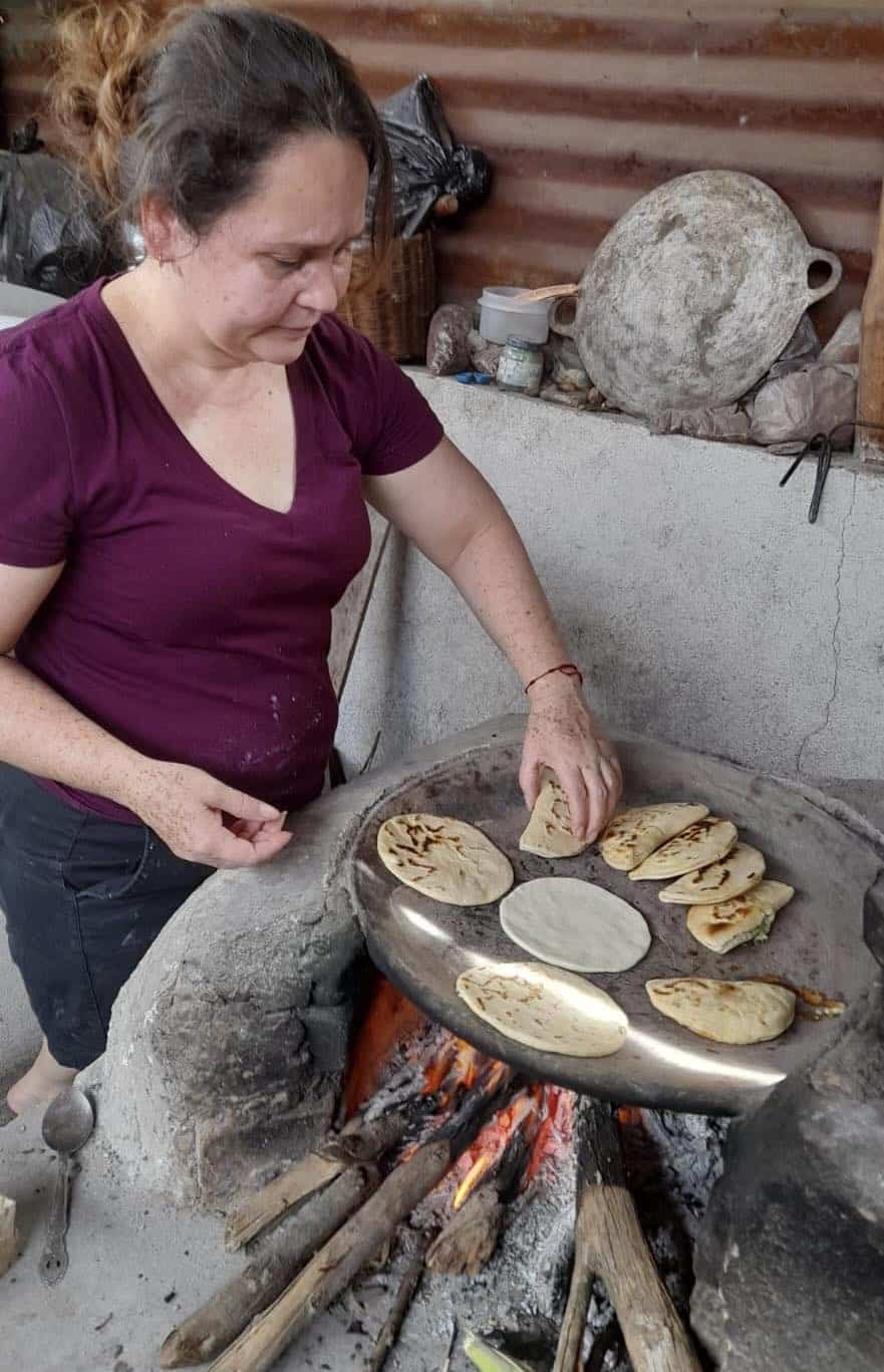 Woman cooking on a comal in Guatemala. 