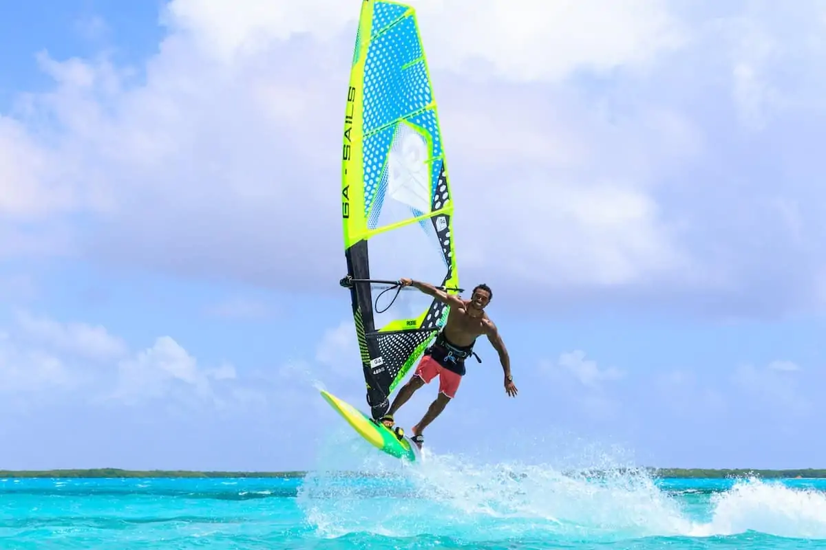 Young man windsurfing in Lac Bay on Bonaire. 