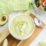 A bowl of avocado lime ranch dressing on the table.