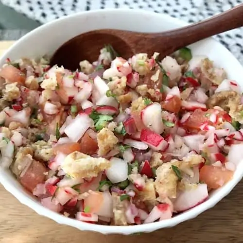 Traditional Guatemalan chojin radish and chicharrones salad in a white bowl.