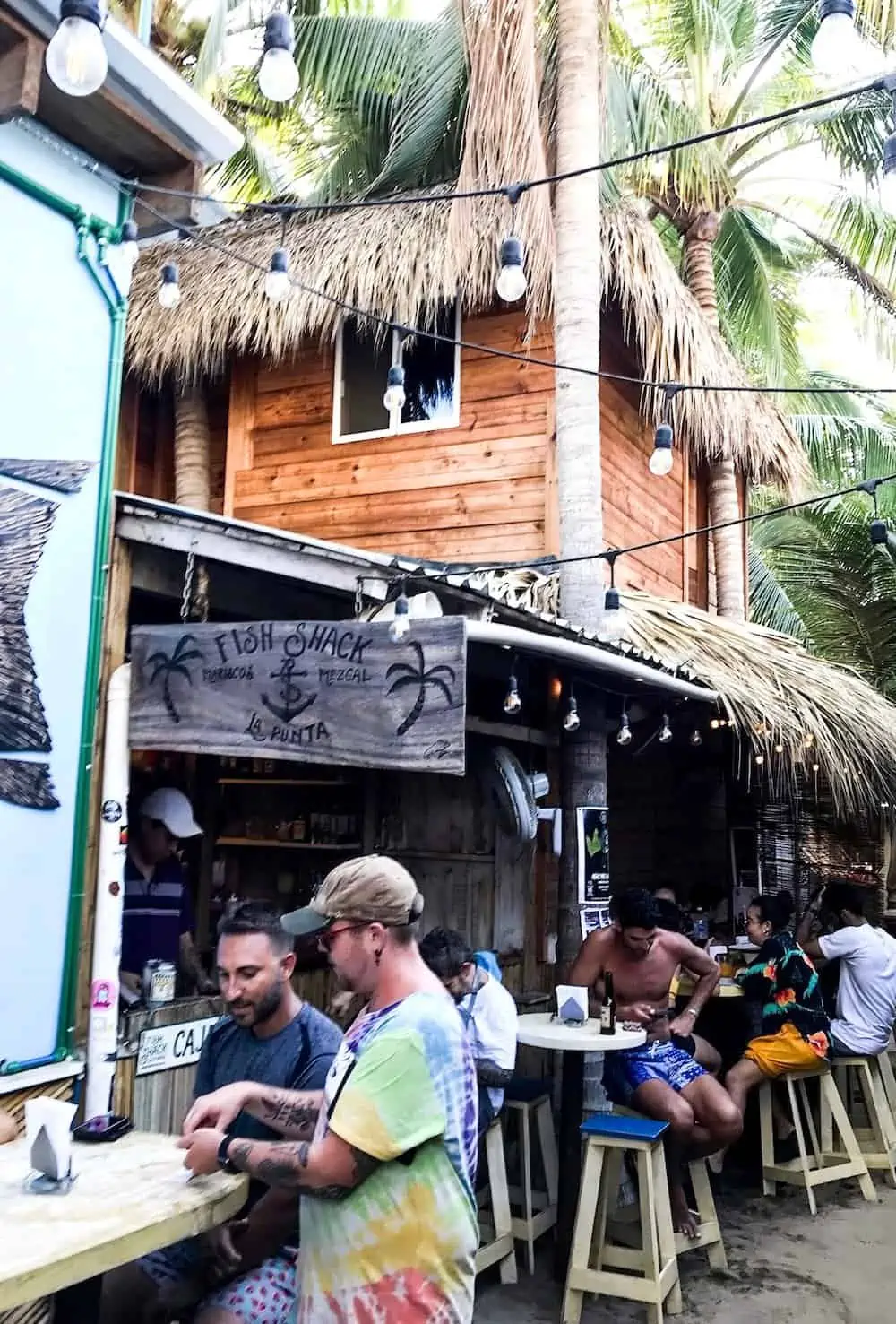 People sitting at Fish Shack restaurant in La Punta, Puerto Escondido.