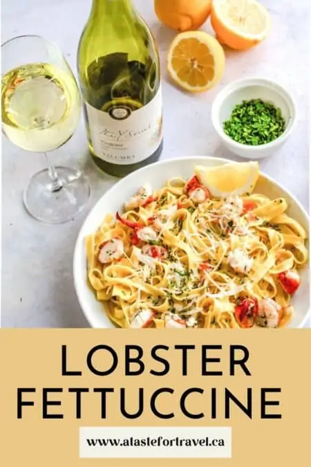 Bowl of pasta with a bottle of white wine.