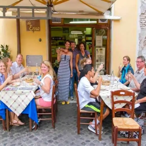Group of people dining at Da Enzo Restaurant in Rome.