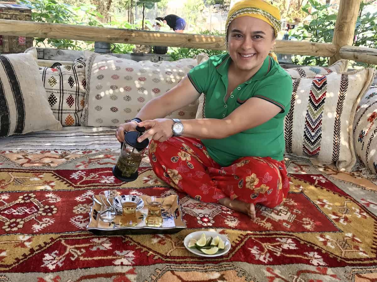 Woman pouring tea a traditional Turkish drink at family-owned Bekiroğlu Olive Oil Factory.