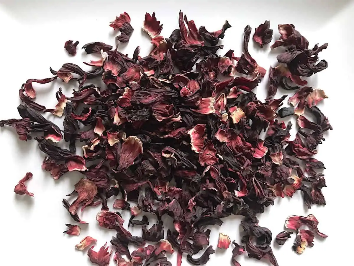 Dried hibiscus flowers on a white plate.