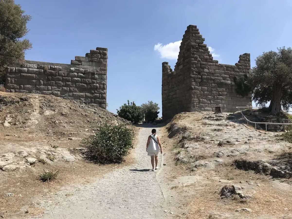 A woman walking through Myndos Gate once part of the fortified walls of Bodrum.