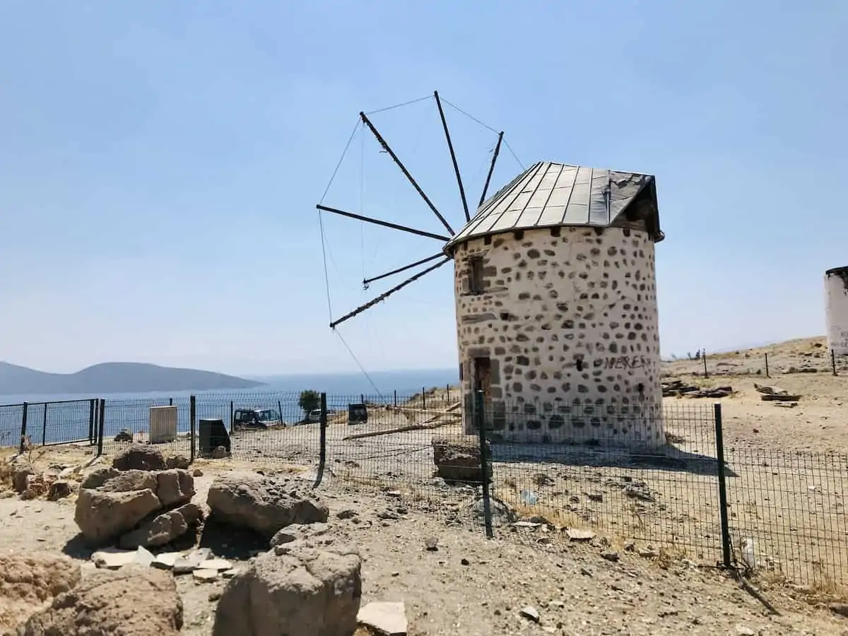 A stone windmill in Bodrum overlooking the sea.