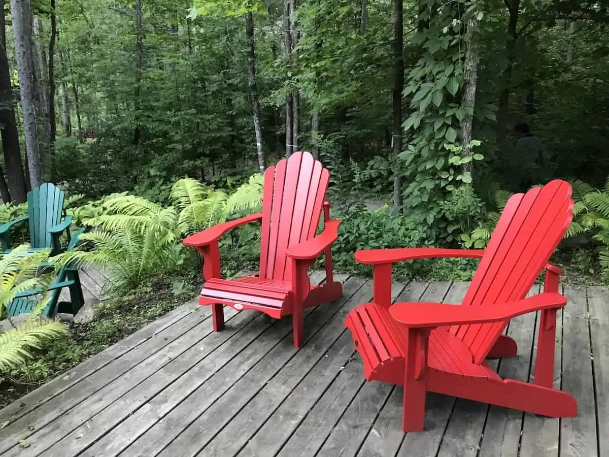 Two red chairs in the forest in Gatineau Park, Quebec. 