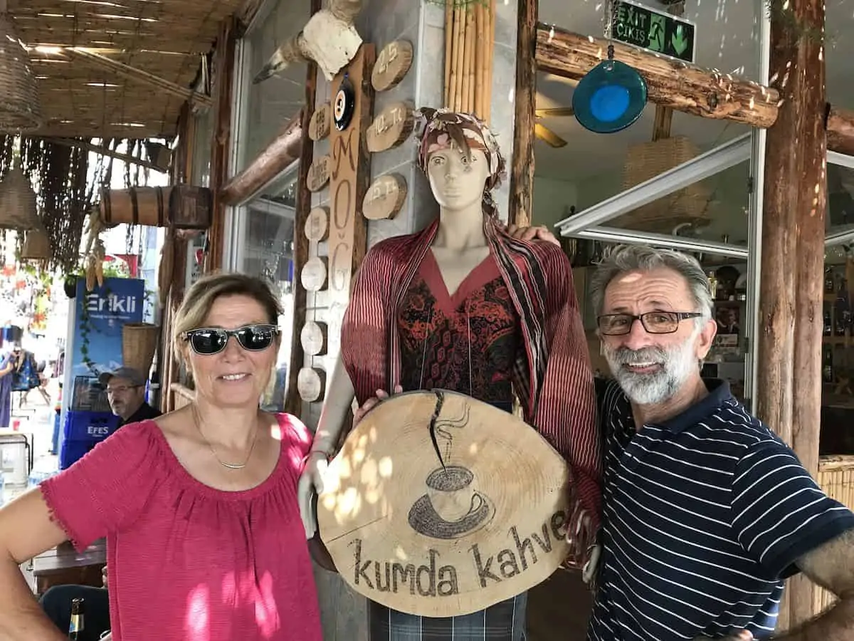 A Turkish man and woman standing in front of a cafe in Turgutreis, Turkey.