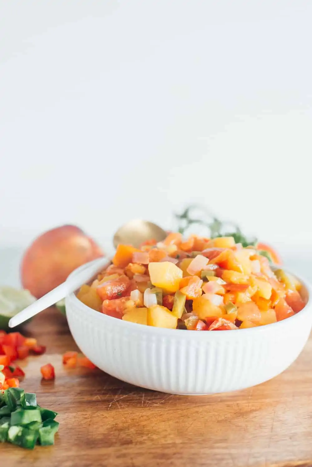 Peach salsa in a white bowl. 