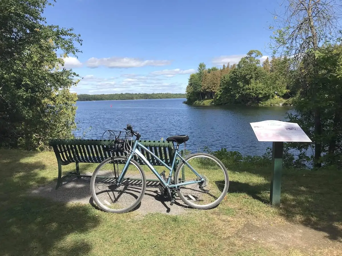 View of a bicycle in front of a bench overlooking Lake Katchewanooka in Lakefield.