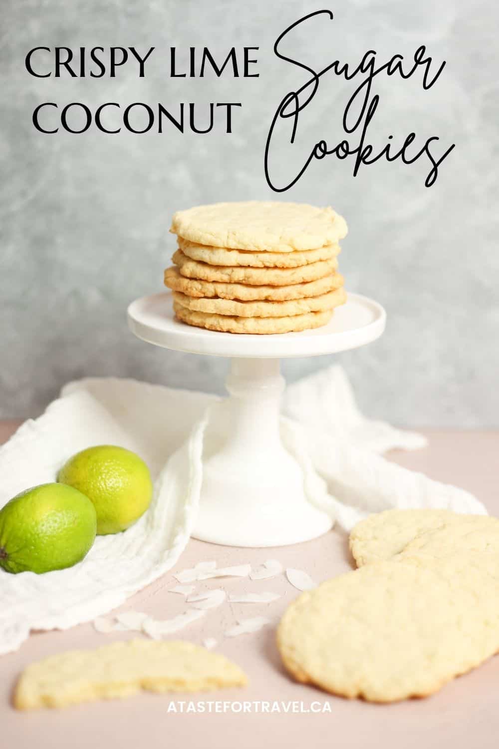 Feature pin for Crispy Lime Coconut Sugar Cookies with a stack of cookies on a white pedestal next to two limes