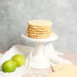 Stack of coconut cookies on a pedestal.