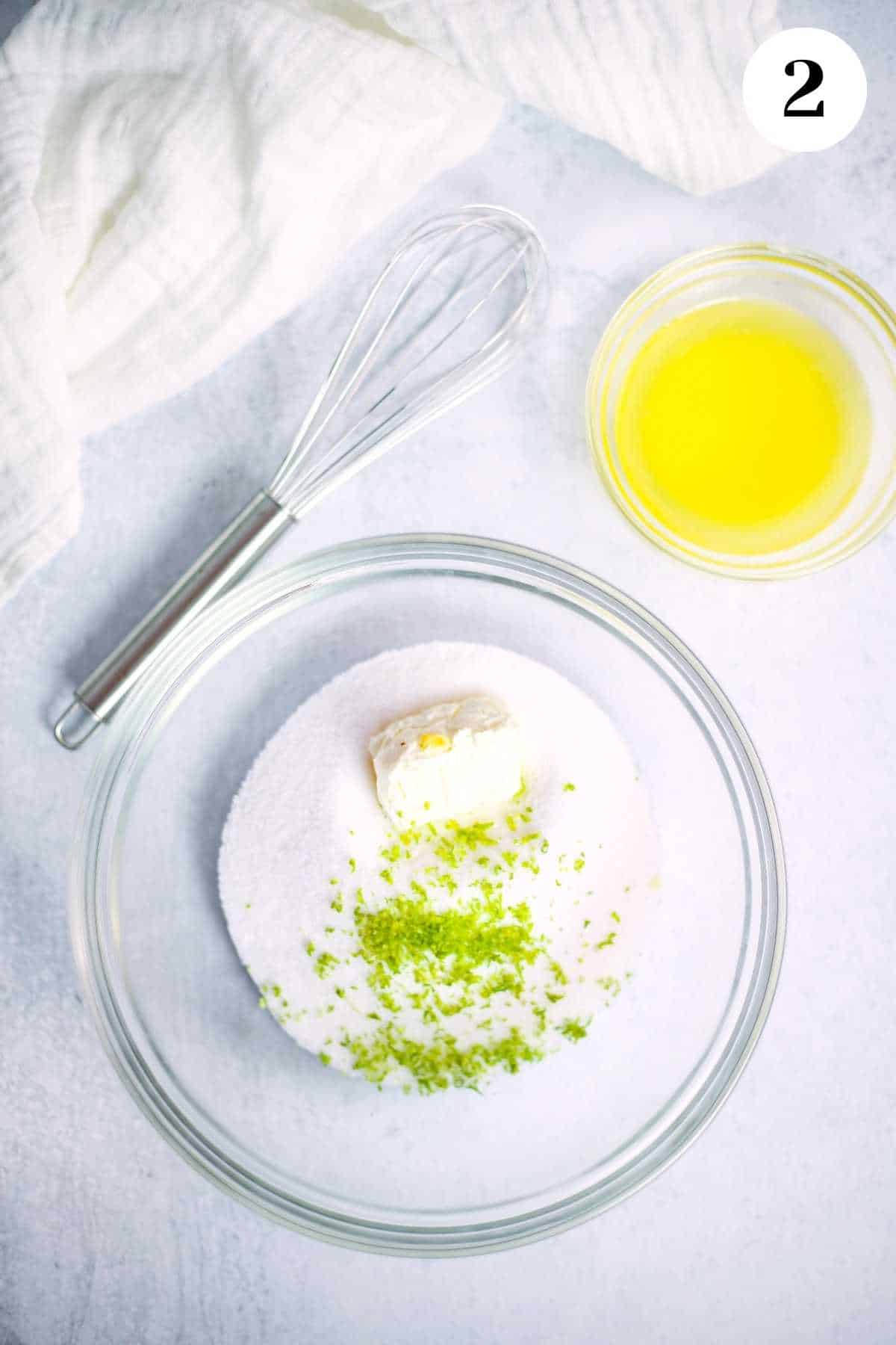 The sugar, cream cheese, and lime zest in a mixing bowl.