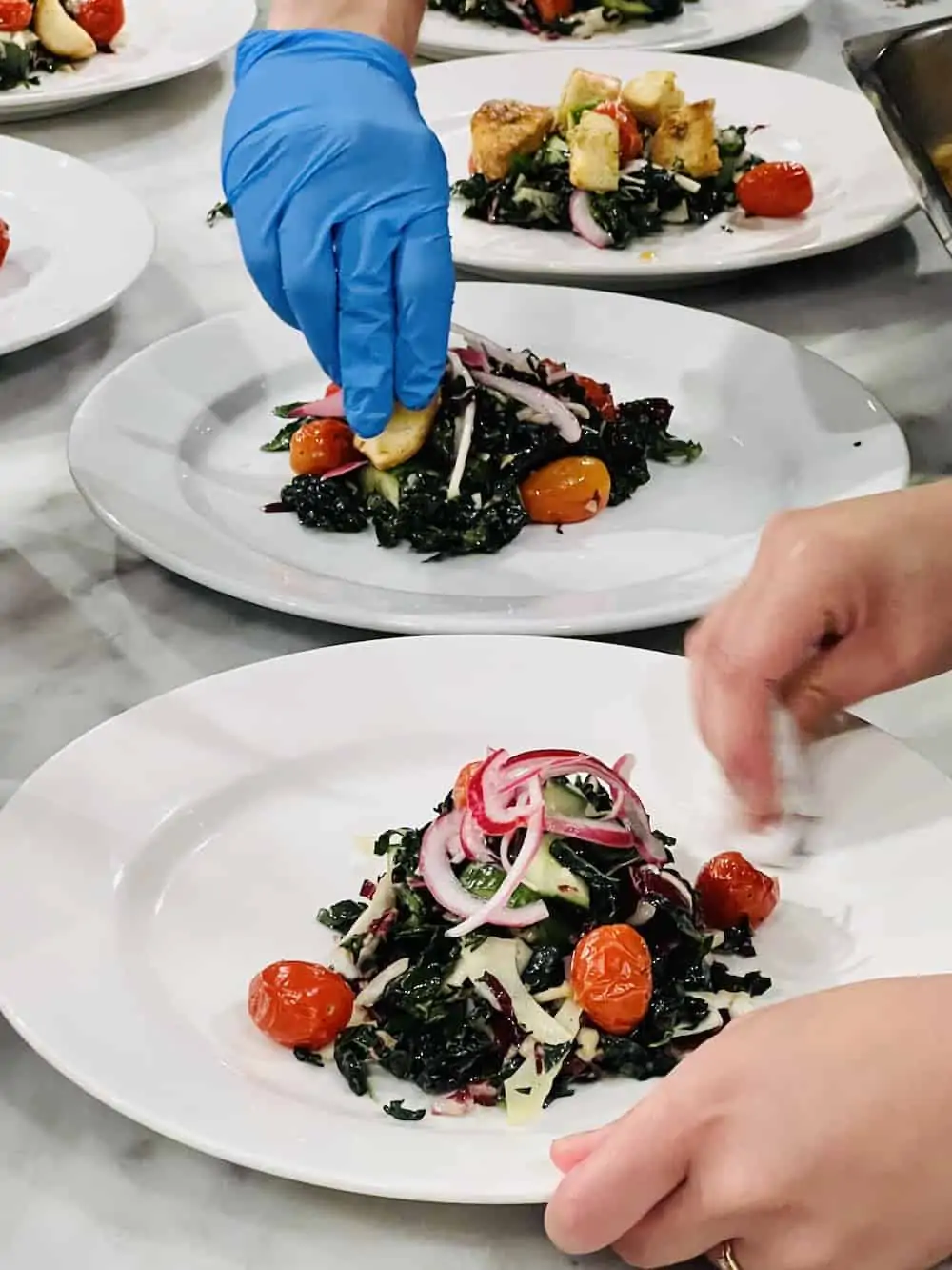 Plating salad at DISH cooking studio. 