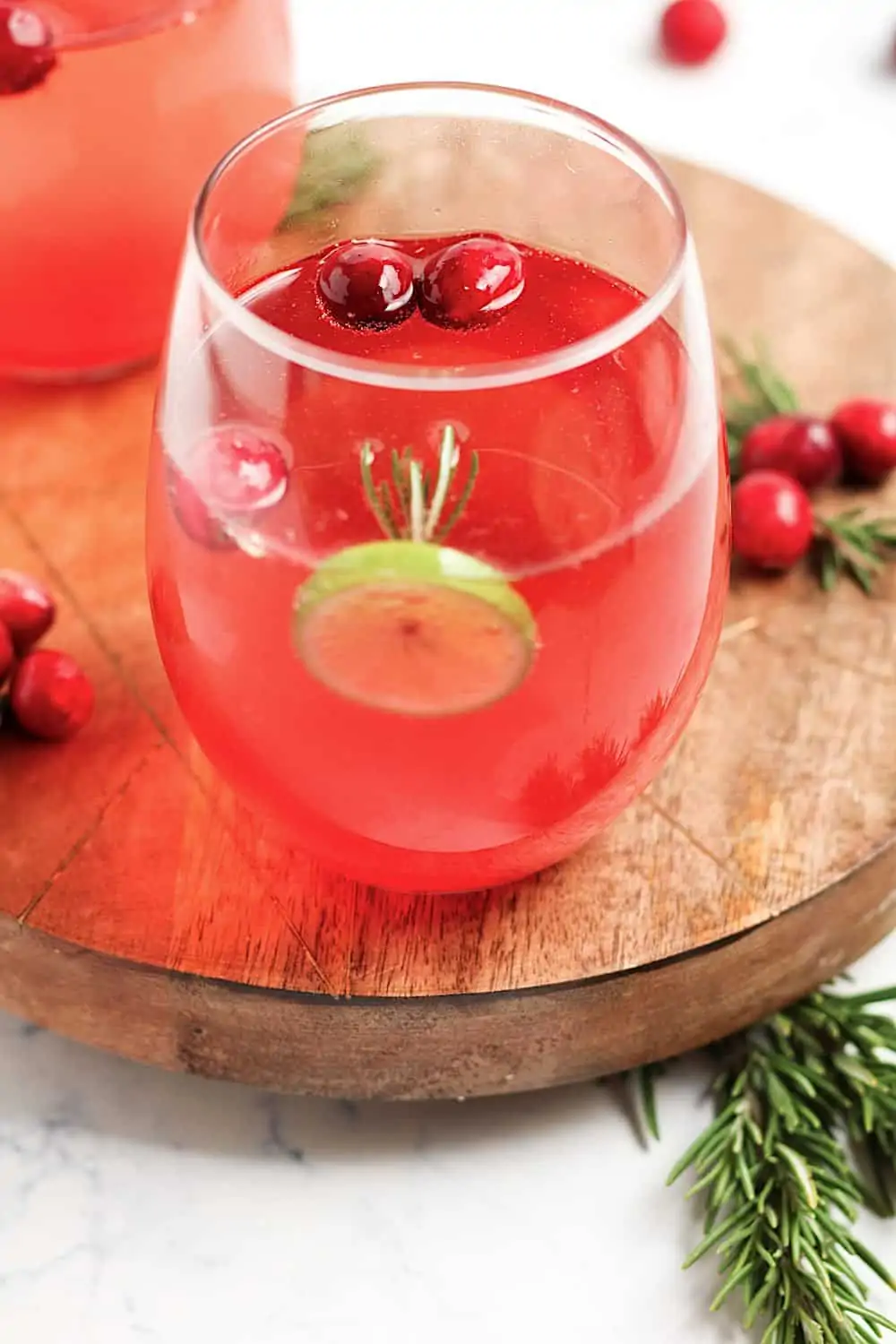 Cranberry and prosecco cocktails on a wooden tray. 