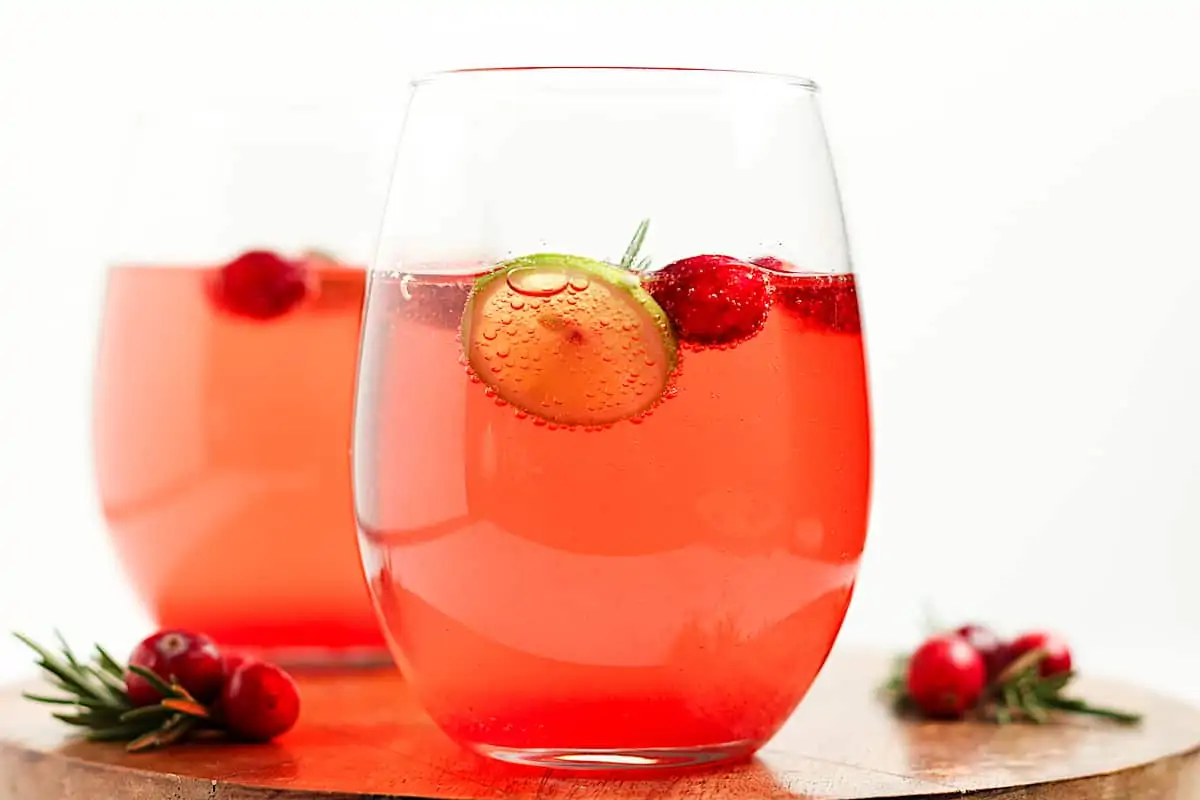 Two glasses of fresh cranberry juice and prosecco in cocktail glassess.