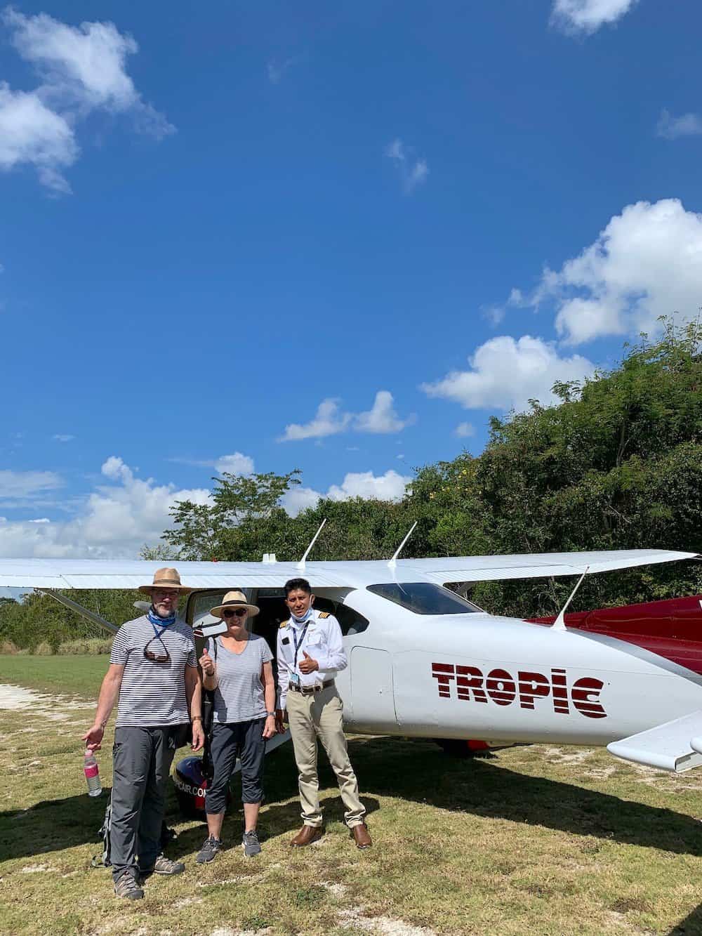 Two people with a Tropic Air aircraft.