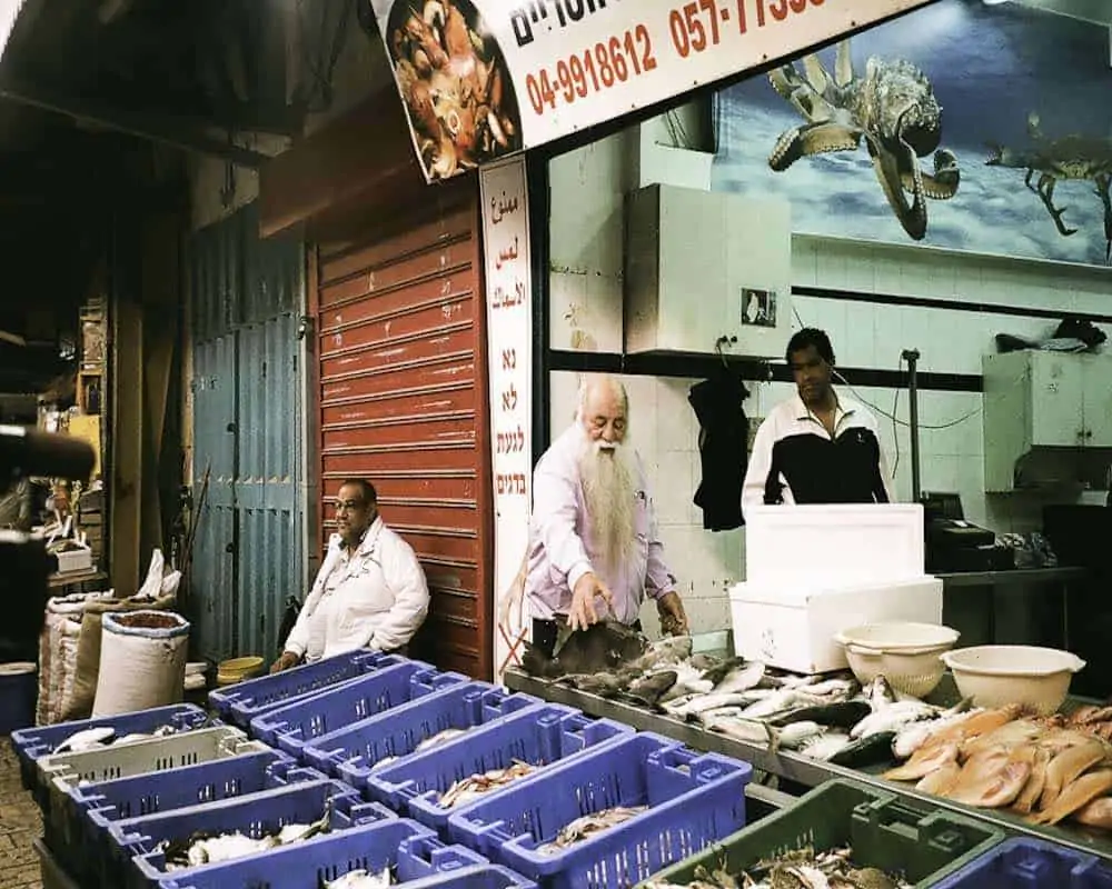 Uri Jeremias at the fish market in Akko.