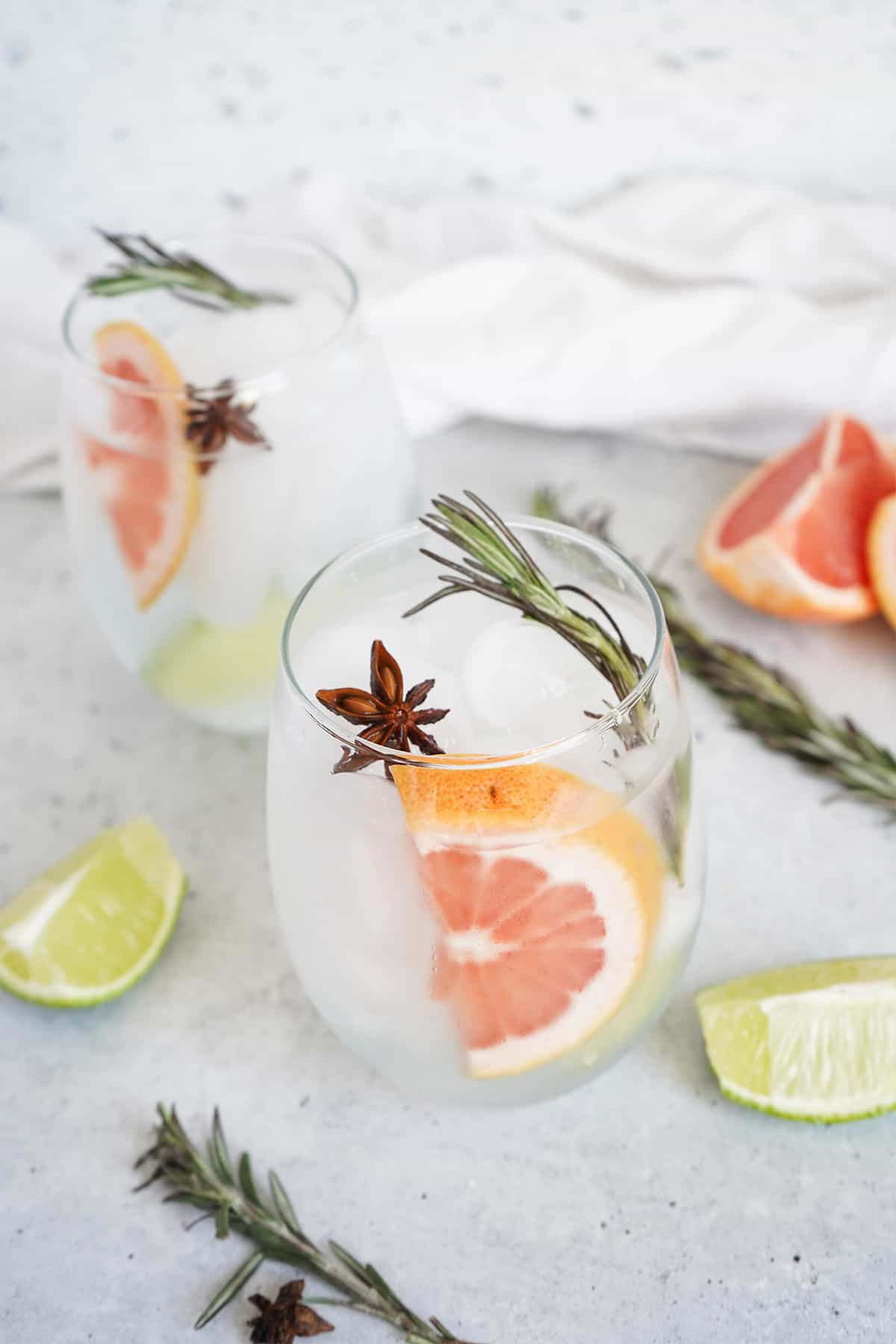 Two grapefruit gin and tonics in clear glasses.