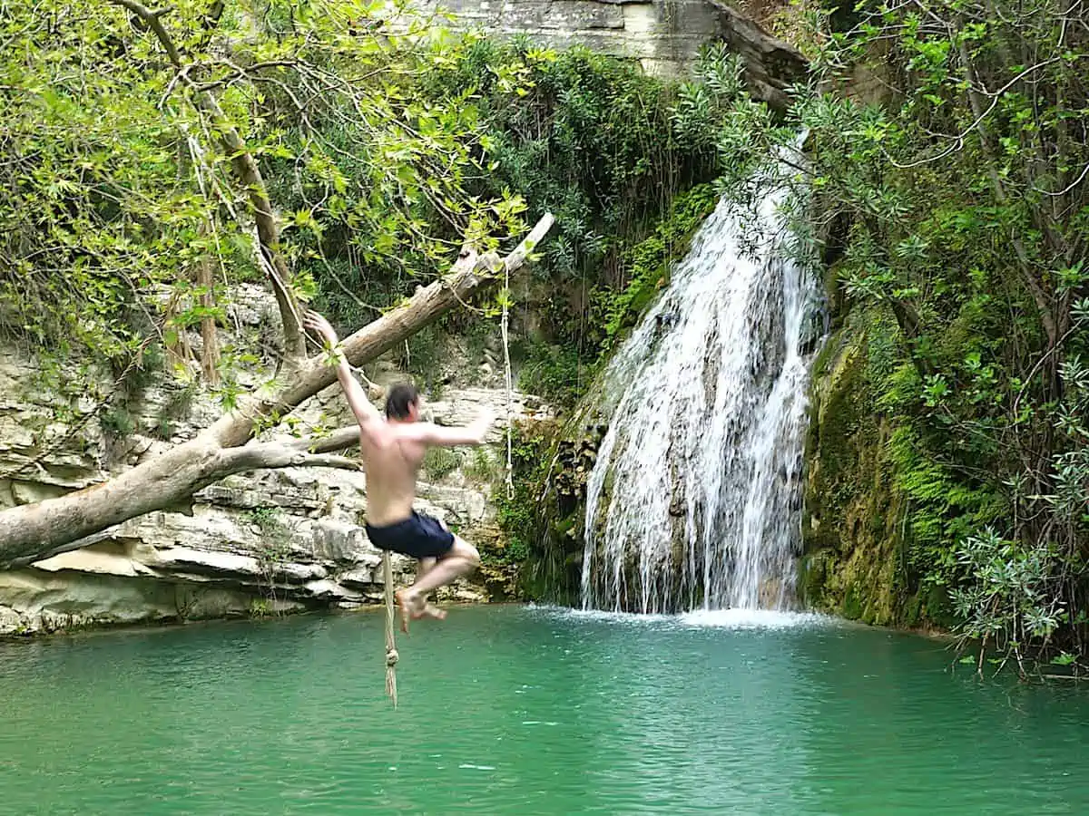 Man jumping into Adonis Falls.