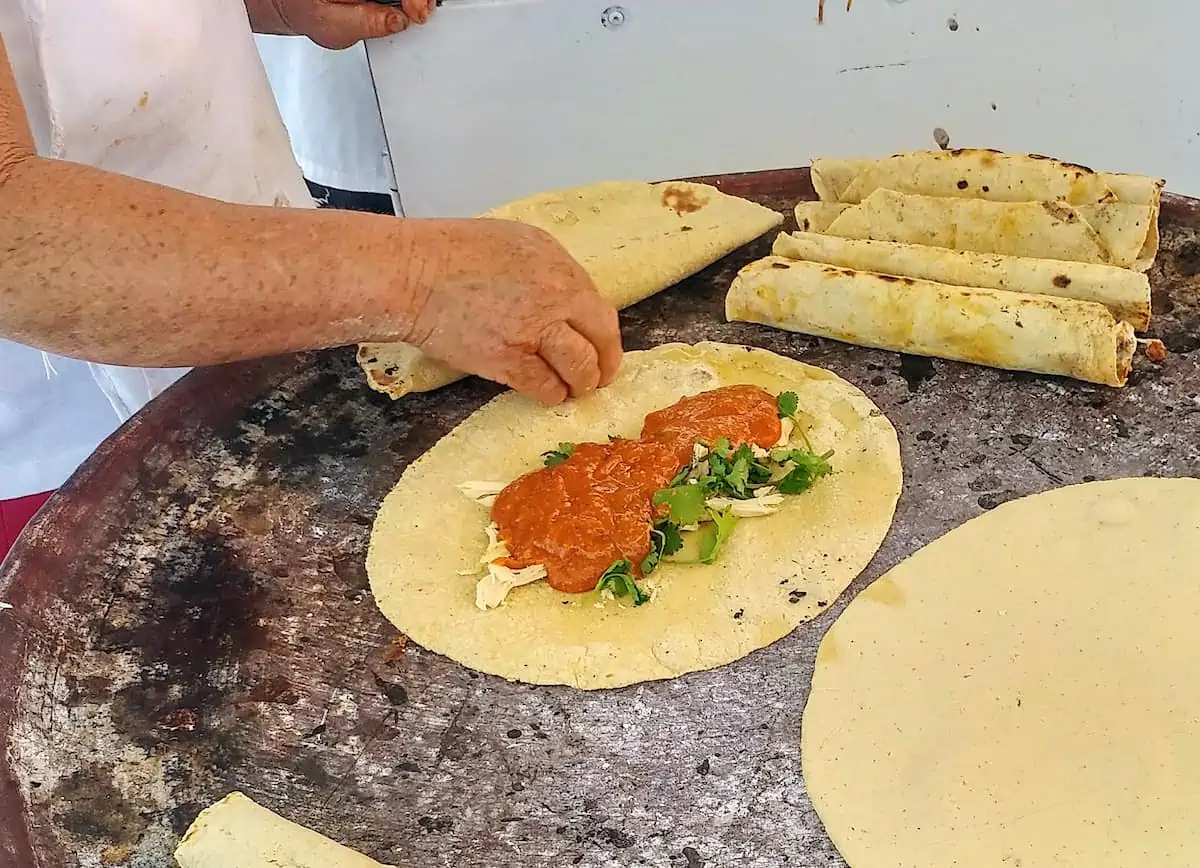 Woman cooking empanadas in Oaxaca Mexico.