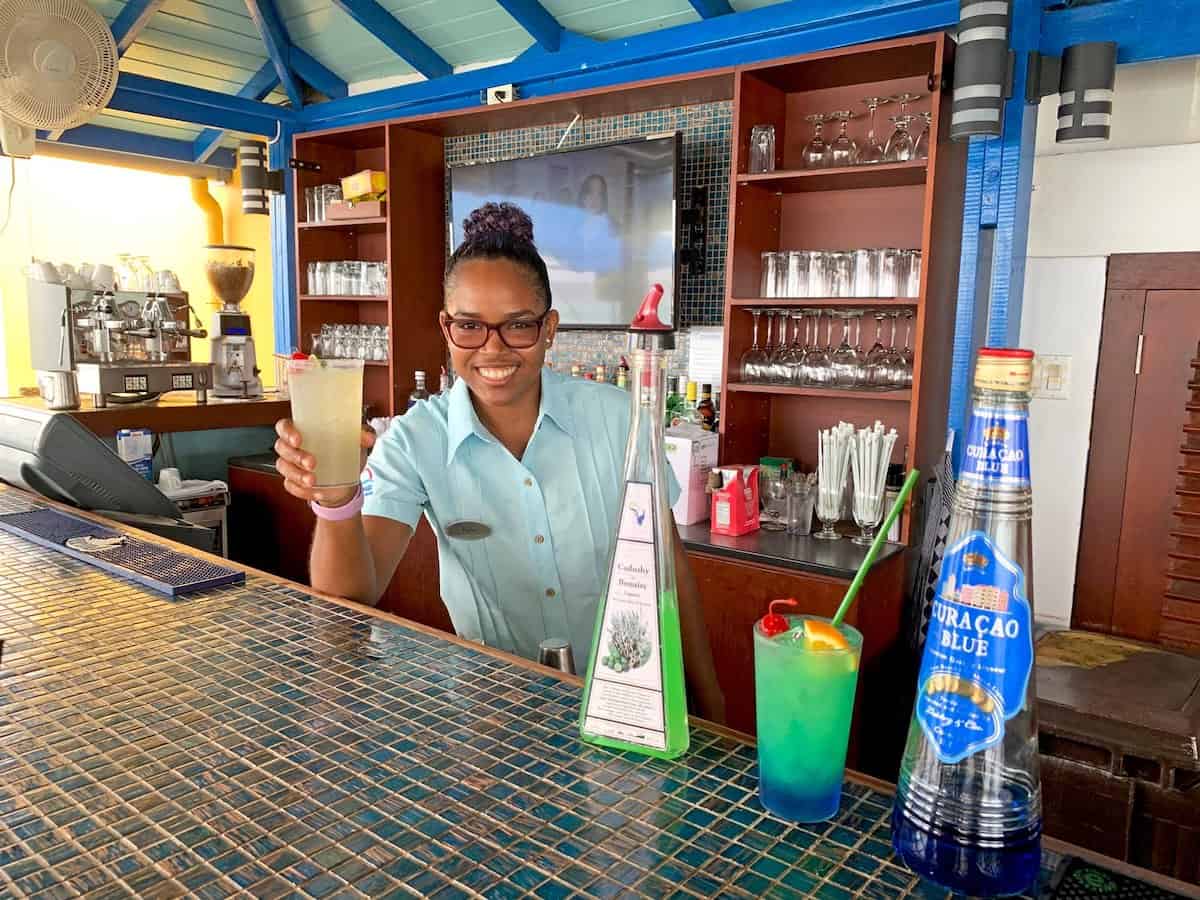 Bartender with a Green Bonaire cocktail at Divi Flamingo Beach Resort.