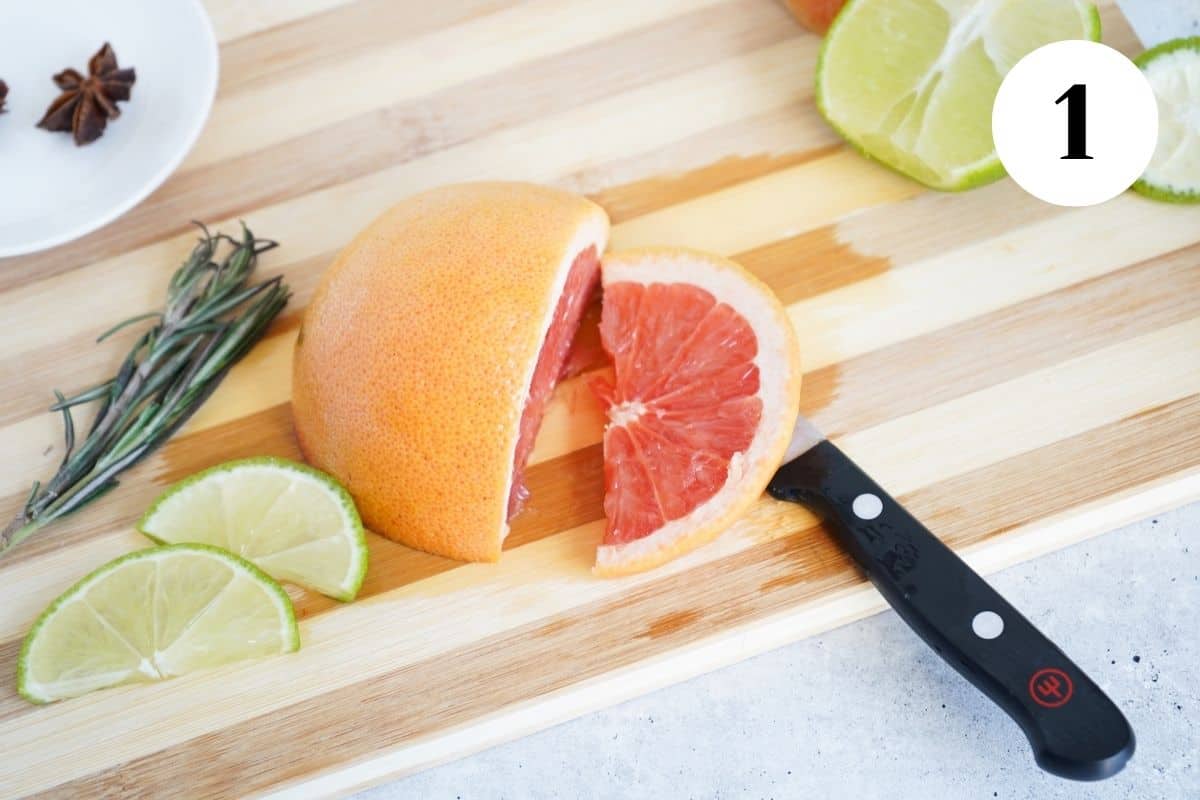 Grapefruit to make spanish gin and tonic on a cutting board.