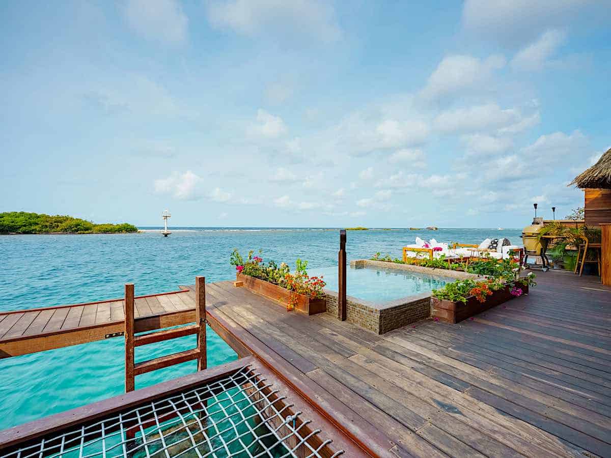 Steps into the water at an overwater bungalow at Aruba Ocean Villas luxury resort.