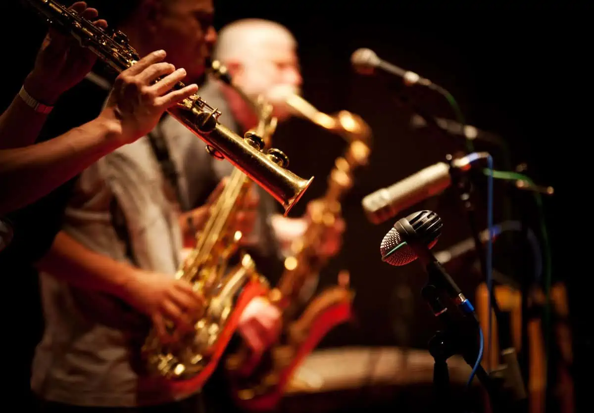 Jazz players in concert playing saxaphone.