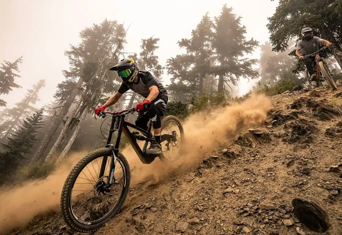 Young men riding bikes in Whistler BC.