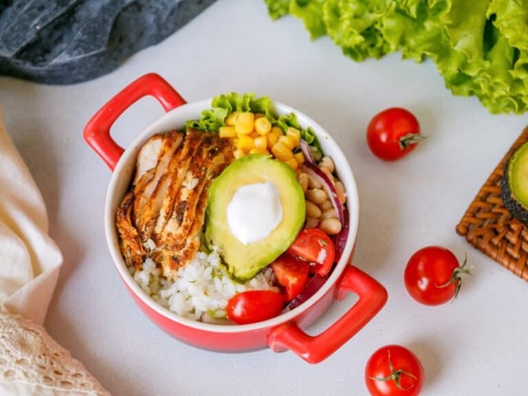 Chipotle chicken and rice bowl in a red dish.