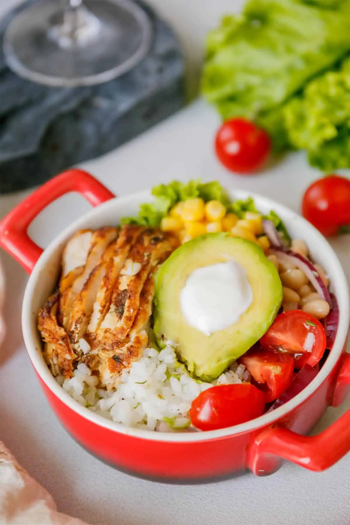A chicken bowl chipotle on the table ready to eat.