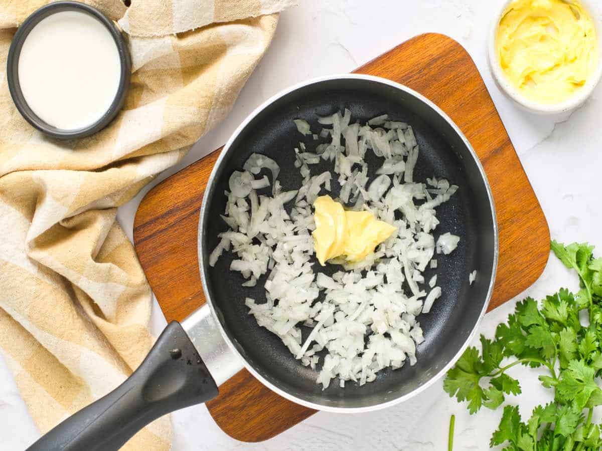 Butter and onions in frying pan.