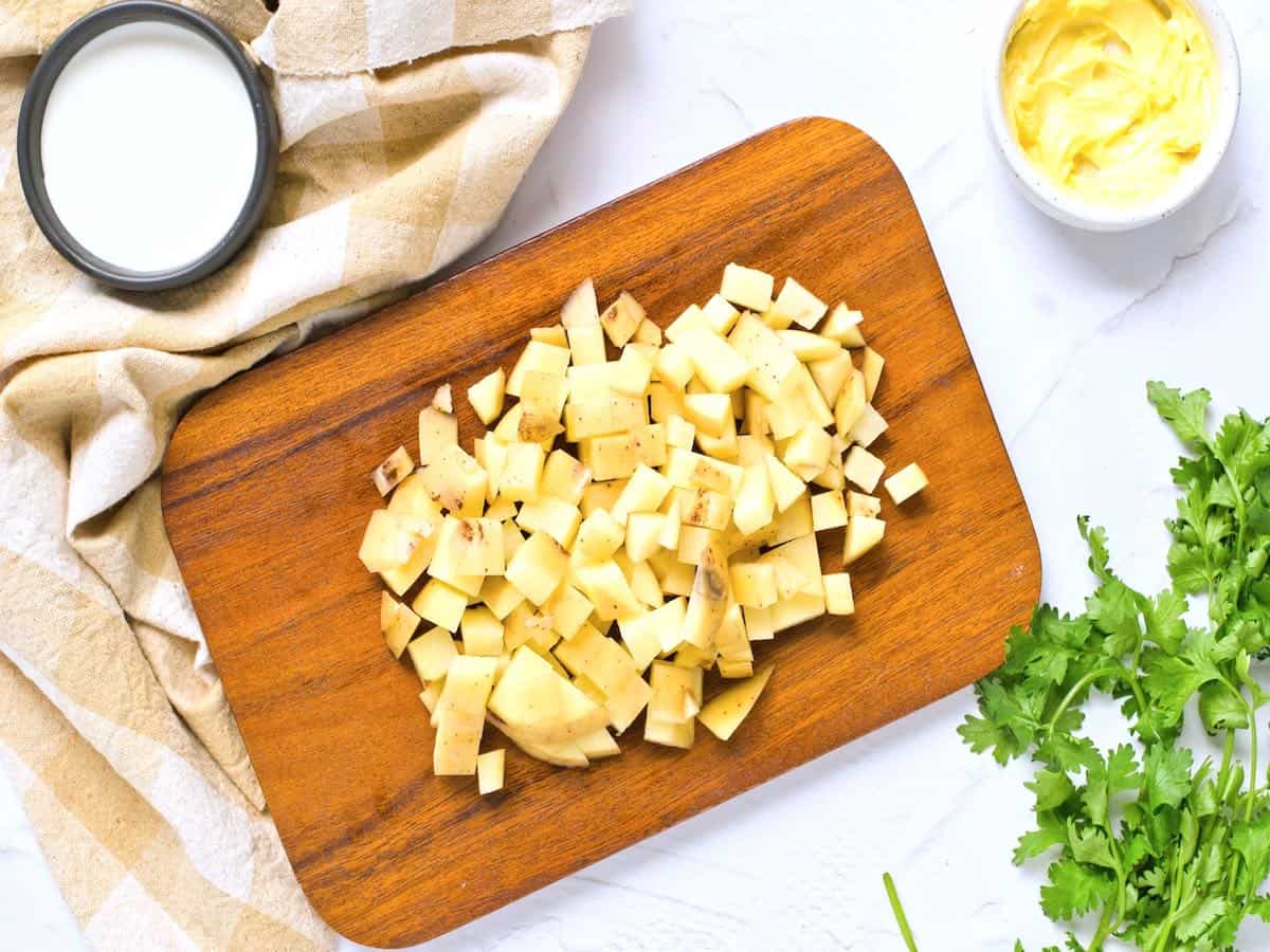 Chopped potatoes on a wooden board.