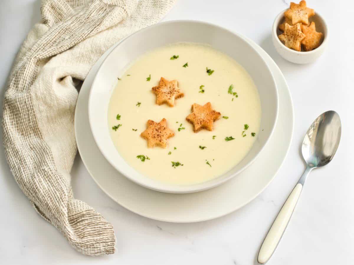 A bowl of Riesling potato soup in a white bowl. oliday 