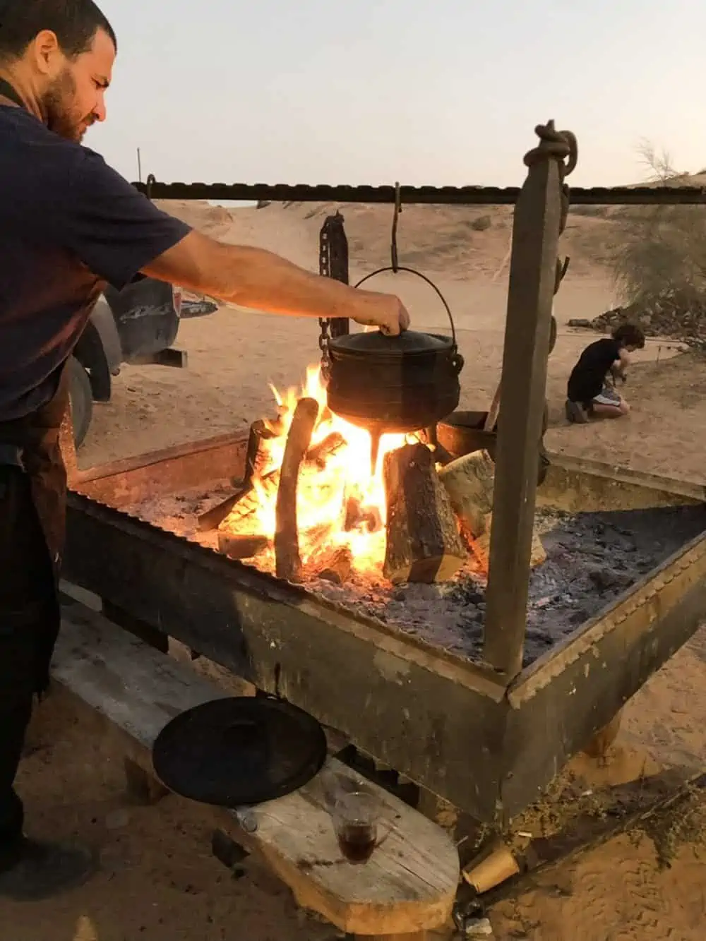 Man cooking in a Poyke pots at Desert Adventure.