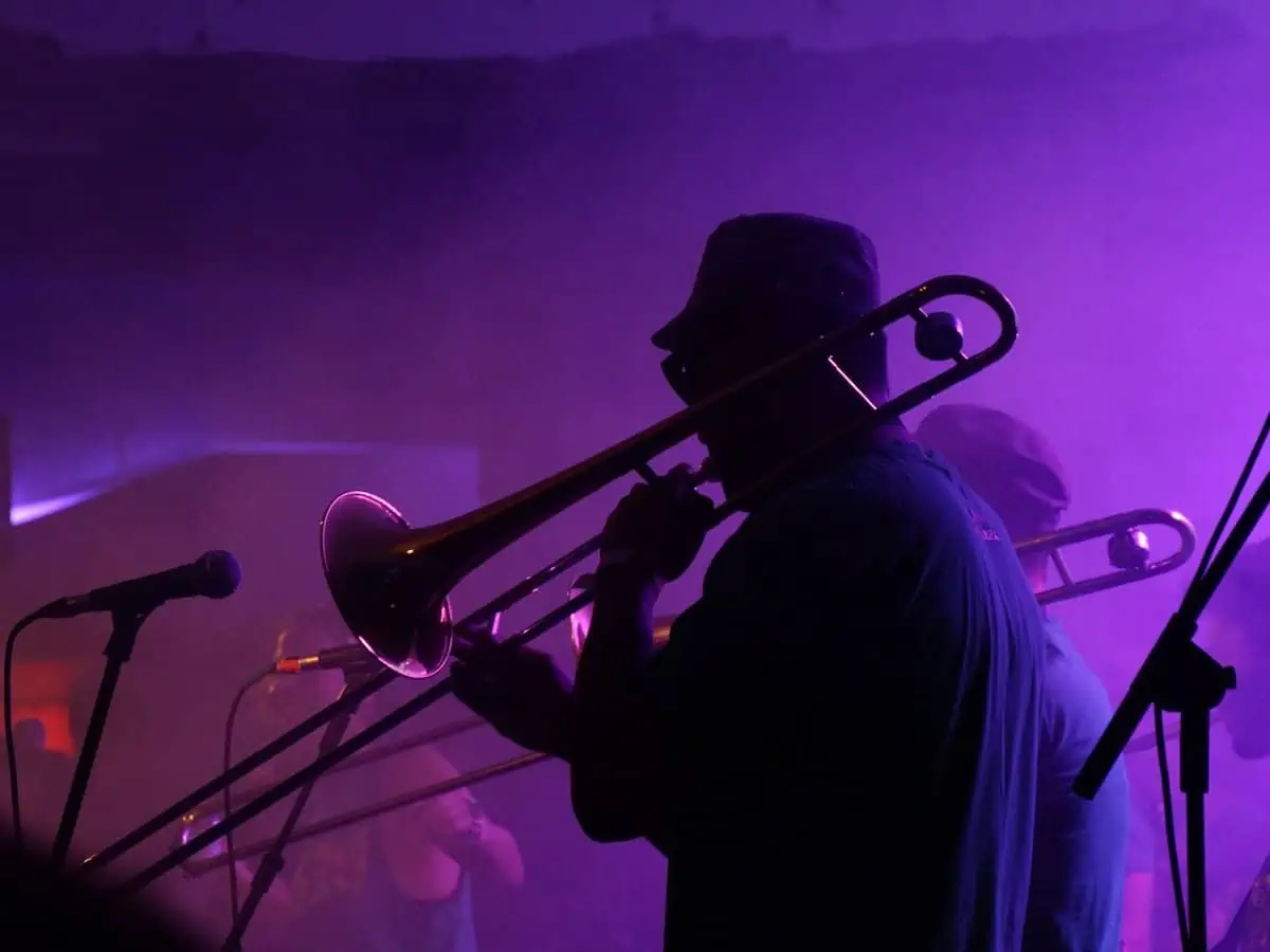 A jazz band playing in purple neon lights. 