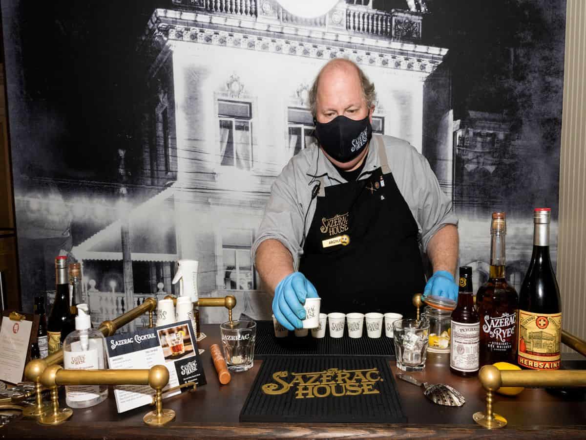 Bartender giving samples of Sazerac. Bartender giving samples of Sazerac.
